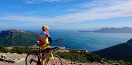 HC Bike Tours founder and ride leader Aigars Paegle enjoying the view of Badia de Pollenca from Albercutx Watchtower in Mallorca, Spain