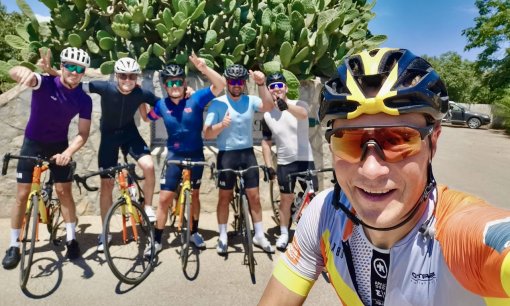 HC Bike Tours founder and ride leader Aigars Paegle with group of cyclists in Mallorca, Spain