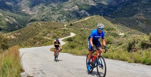 NRG Performance Training athlete climbing a moderate hill during a bicycle ride in Andalucia, Spain