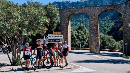 HC Bike Tours guests posing at the turn to Sa Colobra in Mallorca, Spain