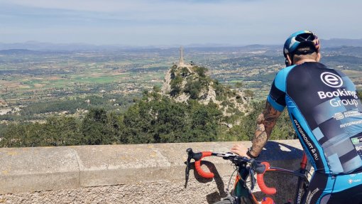 Cyclists enjoying the view at the top of the Sant Salvador climb in Mallorca, Spain.
