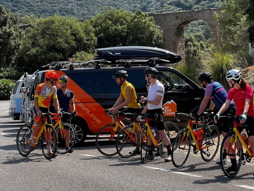 Cyclists getting ready to ride by the HC Bike Tours SAG van in Mallorca, Spain