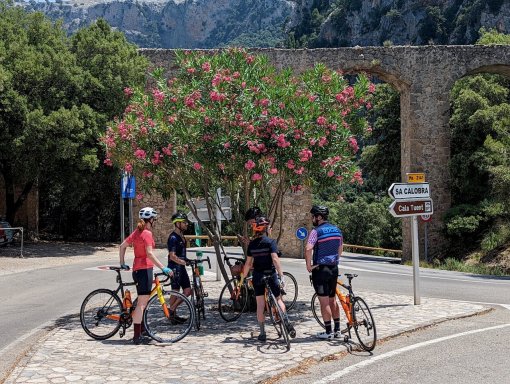 Cyclists regrouping at the turn to Sa Colobra by the aqueduct in Mallorca, Spain
