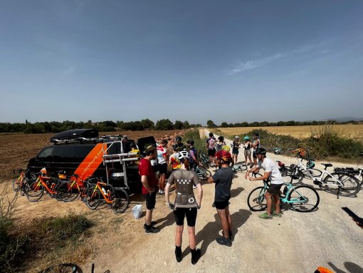 Large group of cyclists stopping for snacks and drinks during a ride in Mallorca, Spain