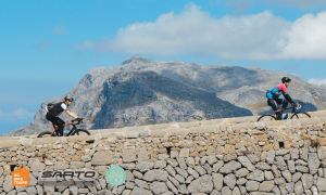 Cyclists reaching top of the Coll dels Reis (Sa Colobra) in Mallorca