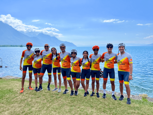 Group photo of cyclists with lake Geneva in the background during a family bike trip from Annecy to Montreux