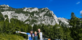 Friends posing for a picture during a ride over Vršič pass during bike trip in Sloveni