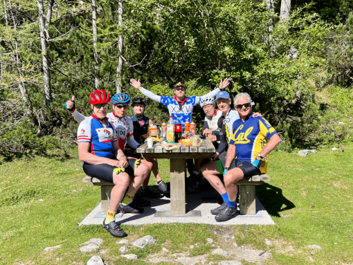 Cyclists enjoying a rest stop at the top of Vršič pass during a bike trip in Slovenia