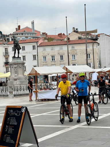 Cyclists exploring the town of Piran on the Adriatic coast during a bike trip in Slovenia