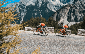 Cyclists riding the cobbled roads of Julian Alps in Slovenia