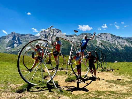 HC Bike Tours guests posing a picture with the big bikes at the Col d'Aubisque during French Pyrenees bike trip in July 2023