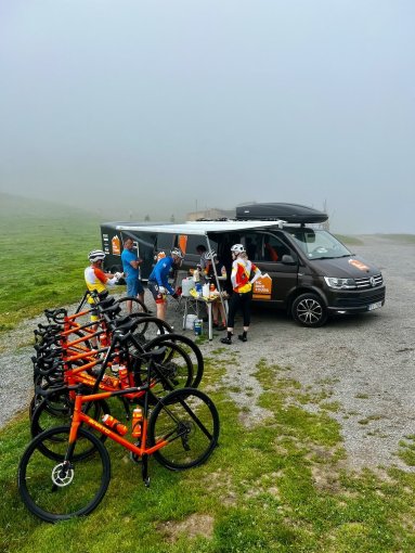 Cyclists enjoying rest stop at Col d'Aspin during a bike trip in French Pyrenees in July 2023