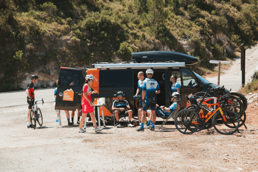 Cyclists resting by the HC Bike Tours support van during NRG PT Europe cycling camp 2023 in Javea, Spain