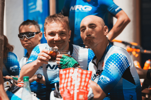 Cyclists enjoying refreshing soft drinks at a cafe stop during NRG PT cycling camp in Javea, Spain