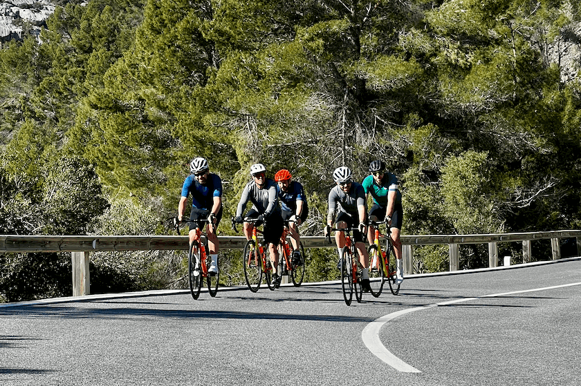 Group of cyclists climbing Coll de Femenia during SAG supported ride to Sa Colobra in Mallorca