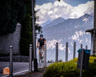 Cyclists finishing the climb on Madonna del Ghisalo during Lake Como bike trip in Italy