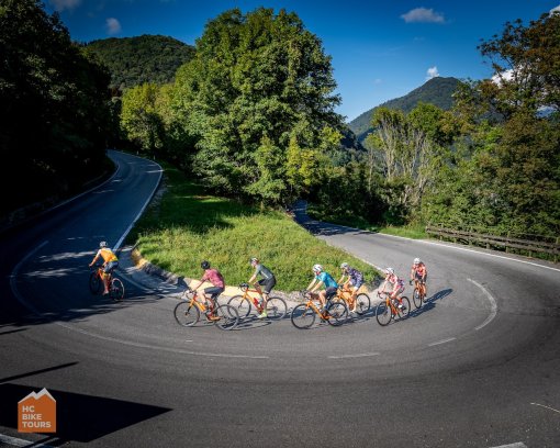 HC Bike Tours guests taking a hairpin turn during Lake Como bike trip in italy