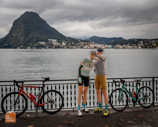 A couple taking a selfie with Lake Lugano in the background