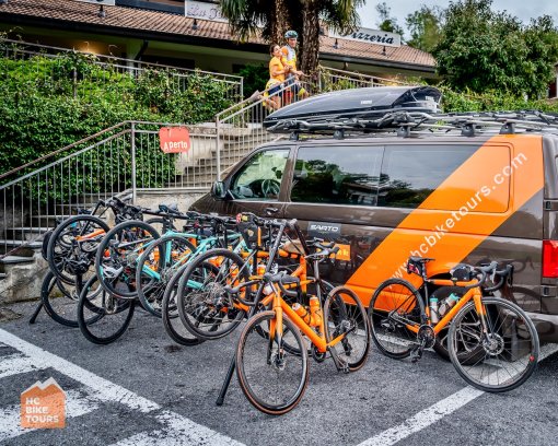 HC Bike Tours support van and bikes neatly hanged during a coffee stop.