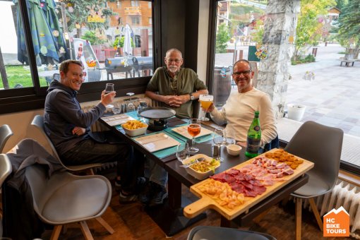 Cyclists enjoying dinner together after a long ride, sharing good company and laughter.