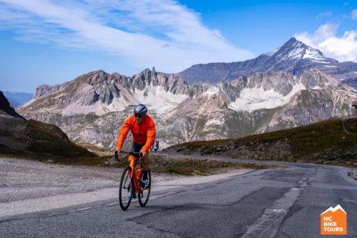 Aigars Paegle, owner of HC Bike Tours, cycling through the scenic French Alps on a clear but cold day