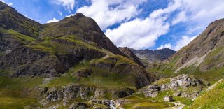 Cycling route winding through green mountains in the French Alps