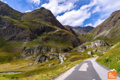 Cycling route winding through green mountains in the French Alps