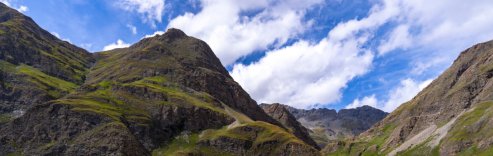 Cycling route winding through green mountains in the French Alps