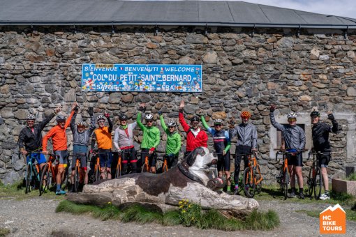 HCBike Tour cyclists team picture in front of the the sign of Col Du Petit Saint_Bernard