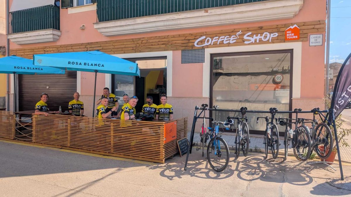 Cyclists sitting on the terrace of HC Bike Tour Coffee Shop