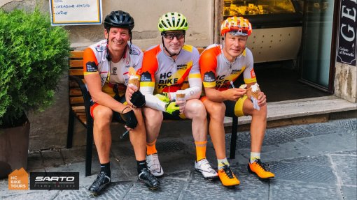 The founder of HC Bike Tours Aigars Paegle (first on the right) having coffee stop with guests while on a bike tour in Tuscany