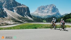 Our guests from the USA cycling Pordoi Pass in the Dolomites Italian Alps