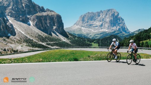 Our guests from the USA cycling Pordoi Pass in the Dolomites Italian Alps